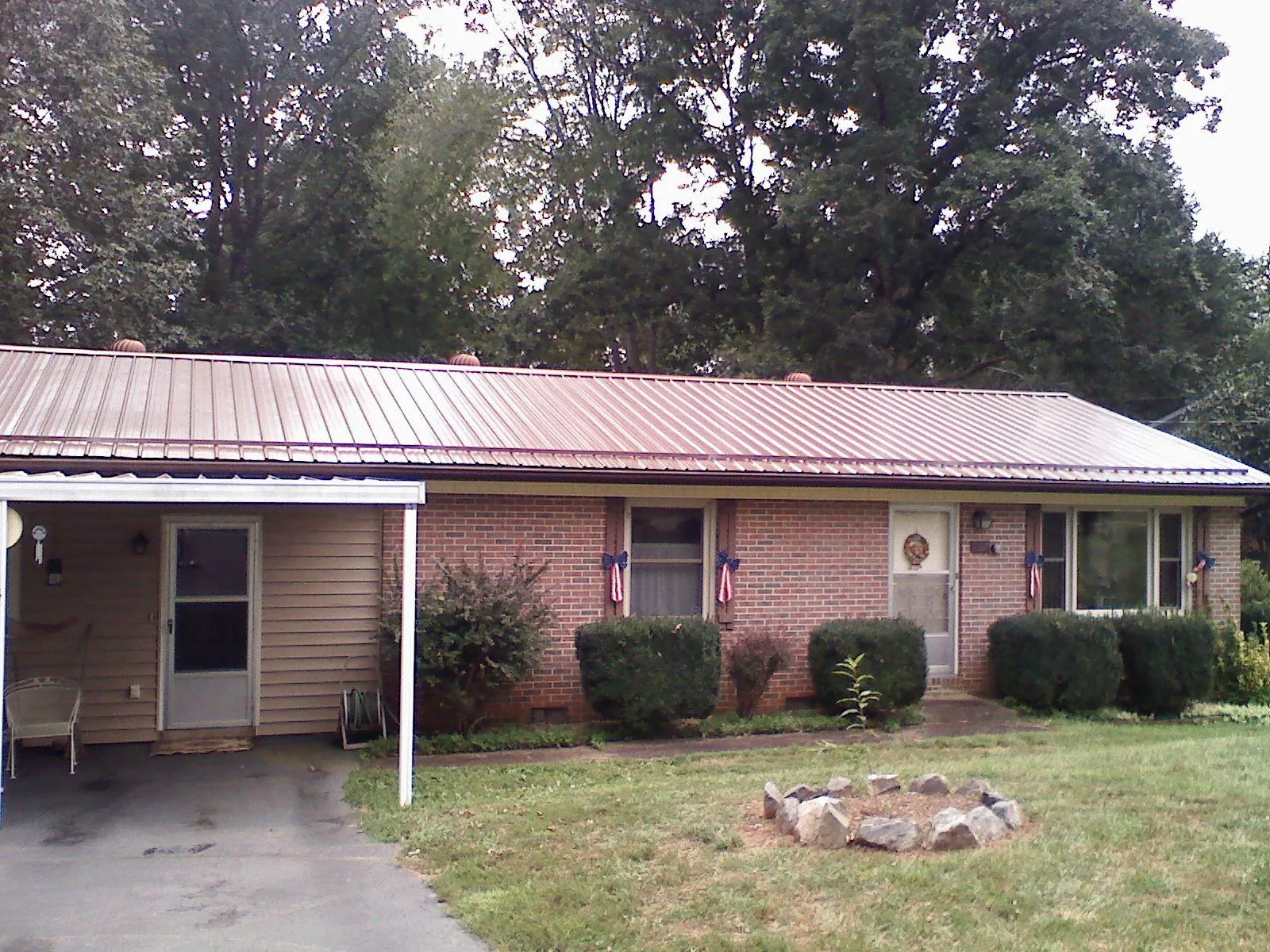 Bronze metal roof and carport on a brick ranch home — Roof Repair work by our crew in Whitehouse Station